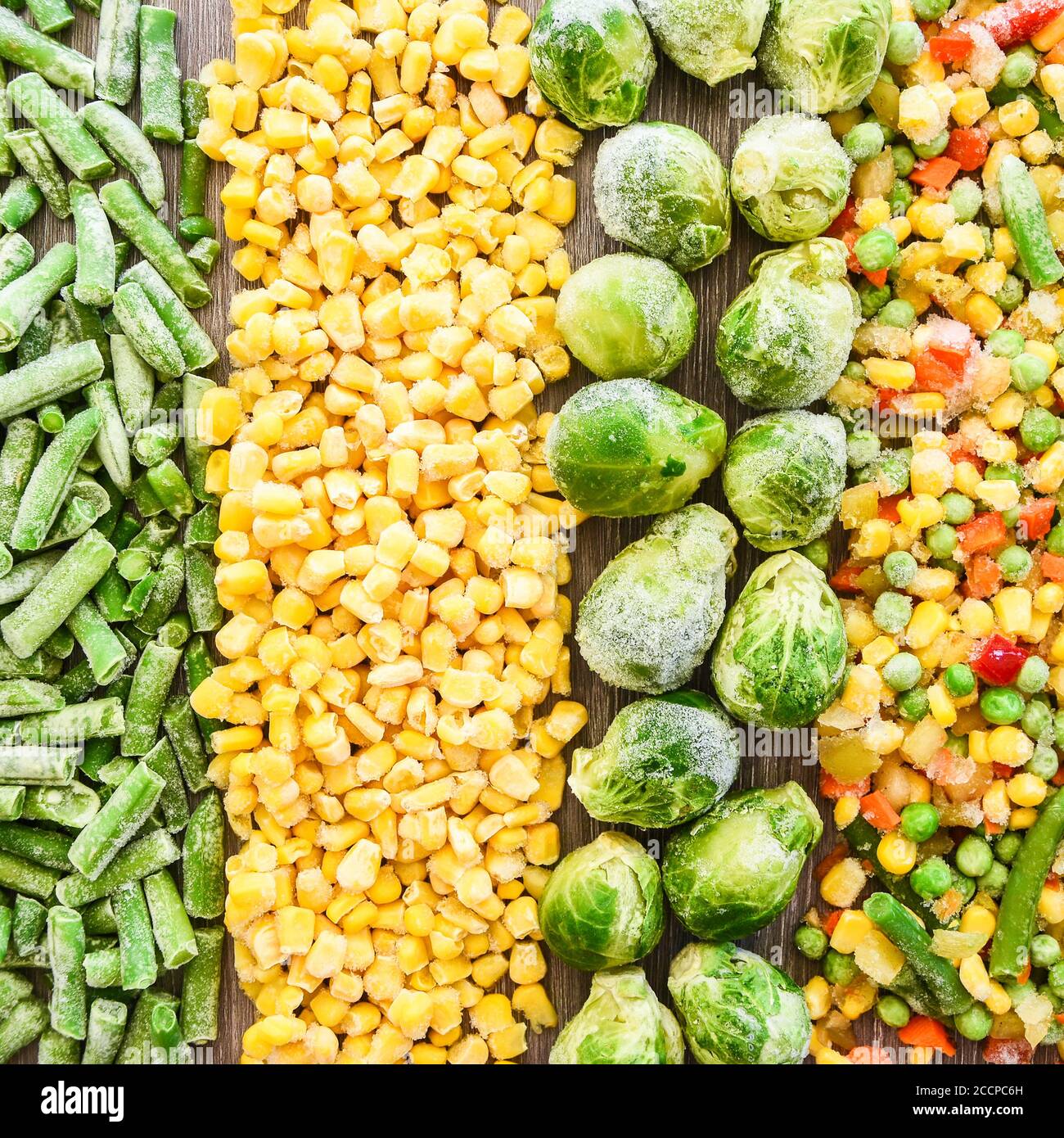 Different frozen vegetables as background, top view. Stocking up vegetables for winter storage