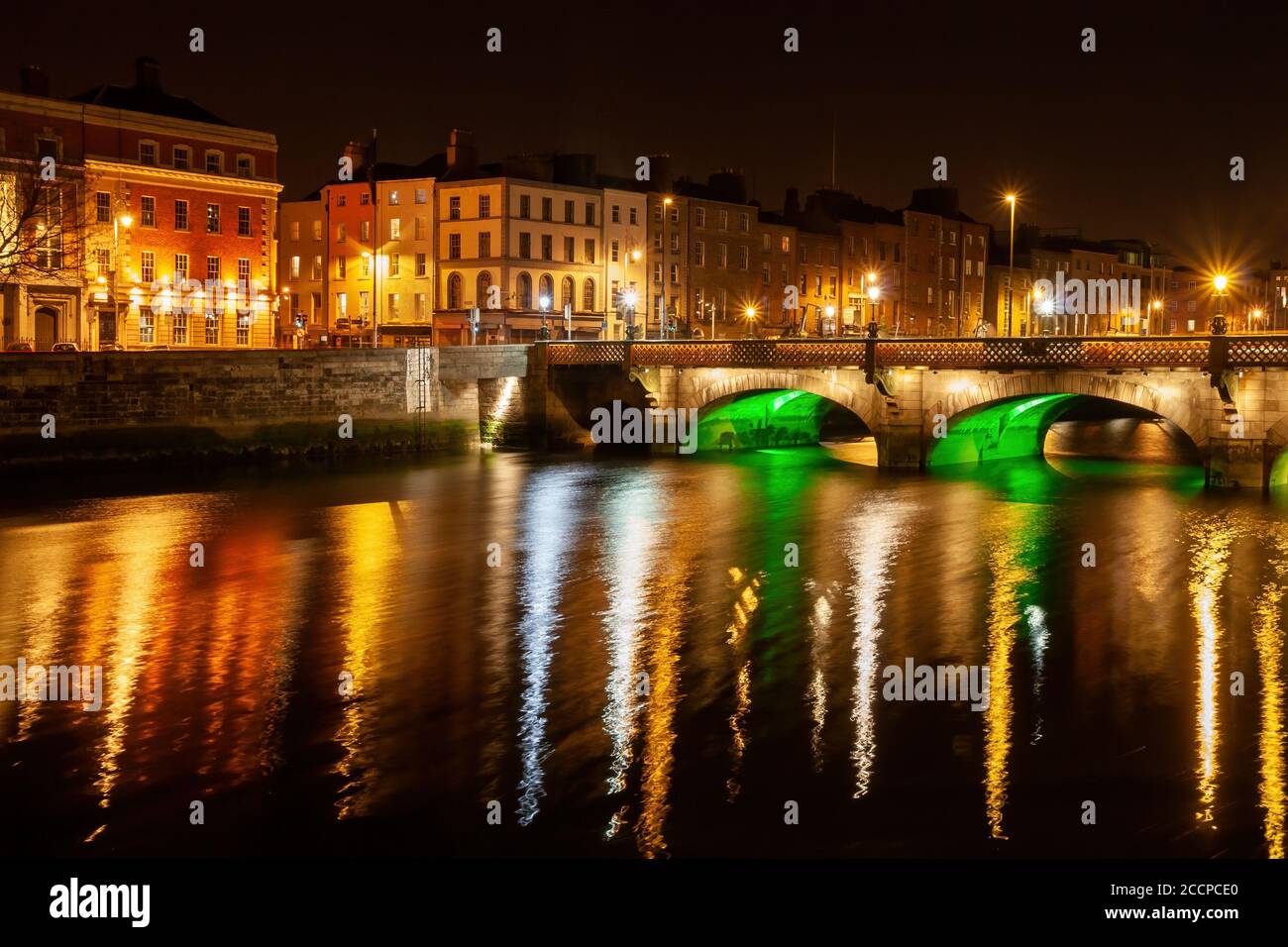 City skyline of Dublin in Ireland, Grattan Bridge on River Liffey at night with reflection in