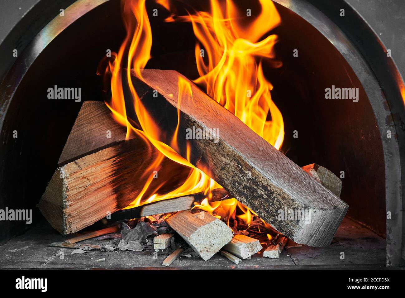 Burning wood emitting flames and smoke after being lit in a pizza oven Stock Photo Alamy