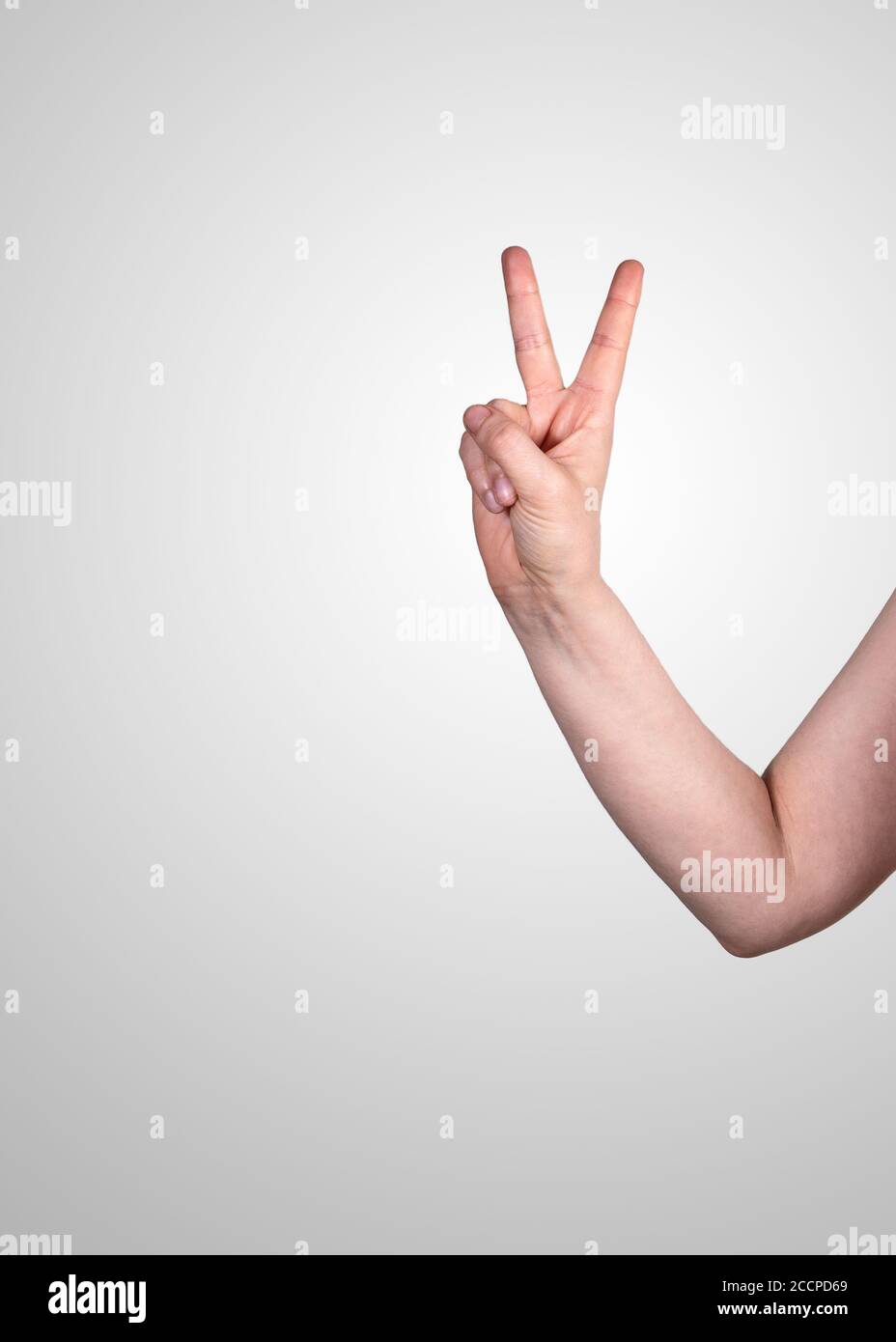 Victory Position Victory or gesture of freedom. Womans hand on a gray background.Policy ...