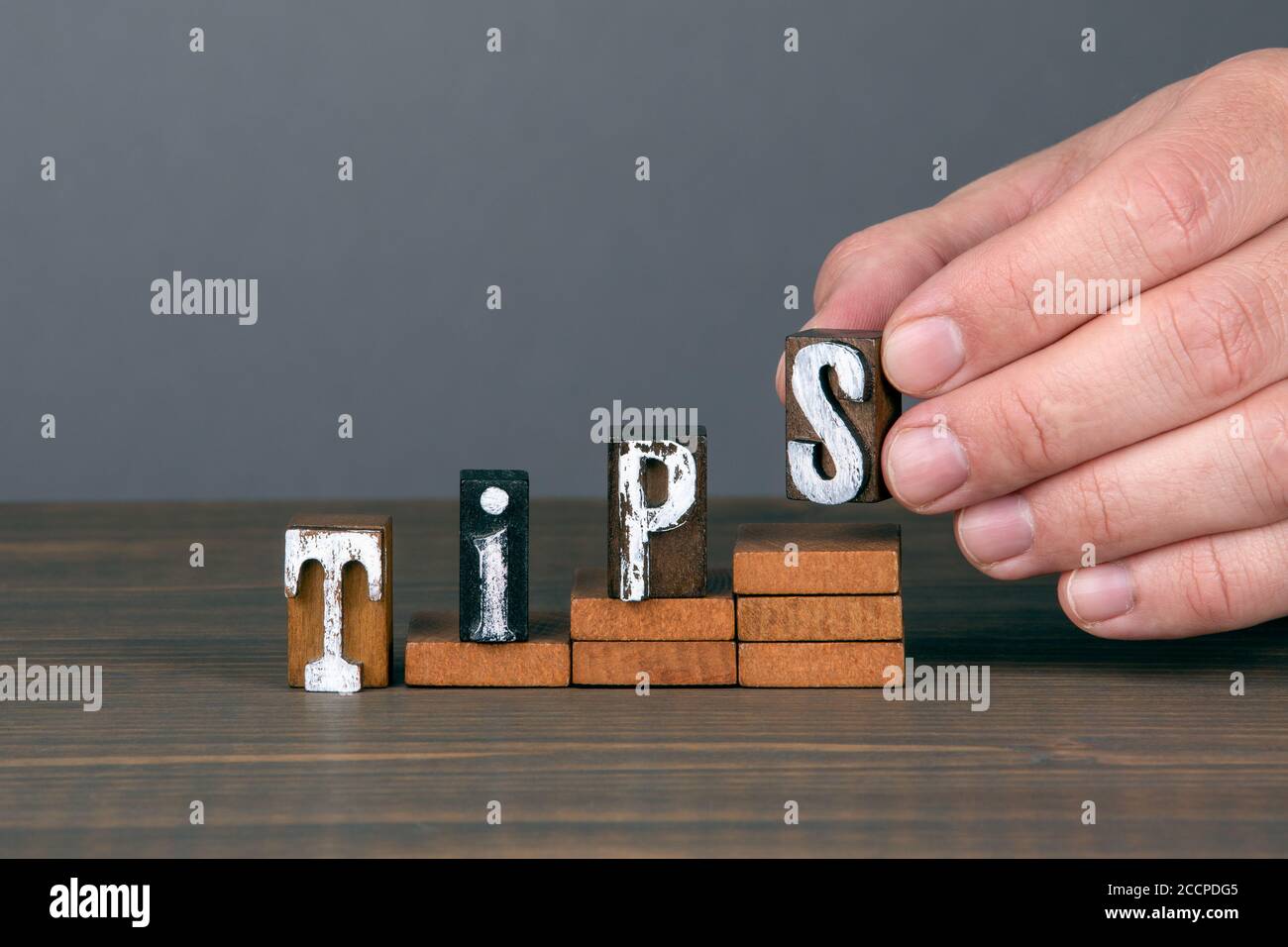 TIPS. Training, service and quality concept. Wooden alphabet letters on ...