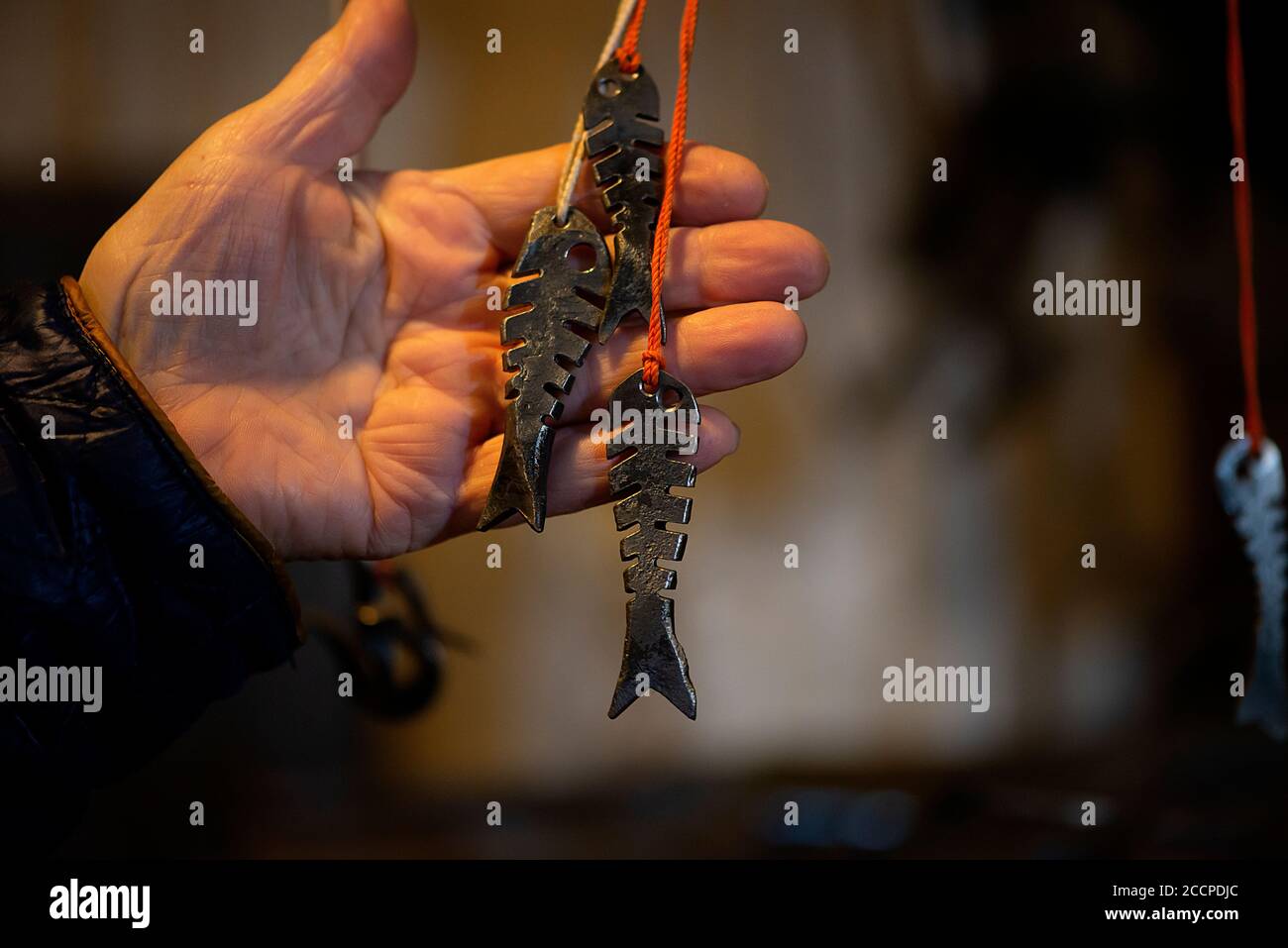 Blacksmith decorative elements metal fish hanging at forge, workshop. Handmade, craftsmanship and blacksmithing concept Stock Photo