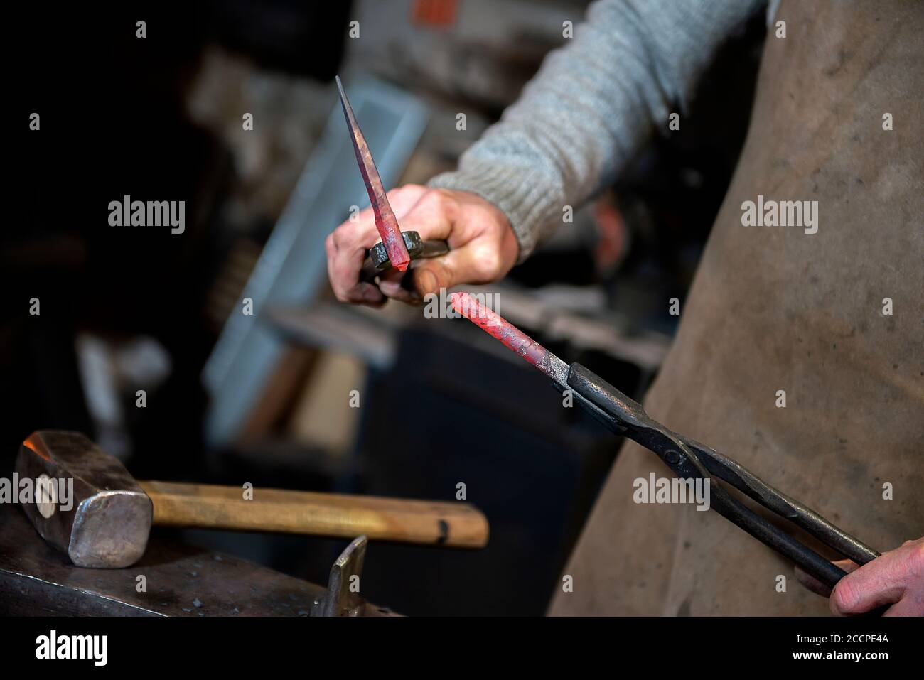 blacksmith working on an anvil Stock Photo