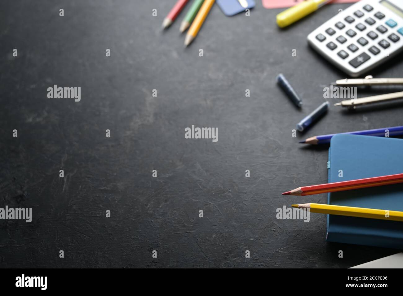 Stationery school supplies on one side of a dark background, office and education concept, copy space, selected focus, narrow depth of field Stock Photo