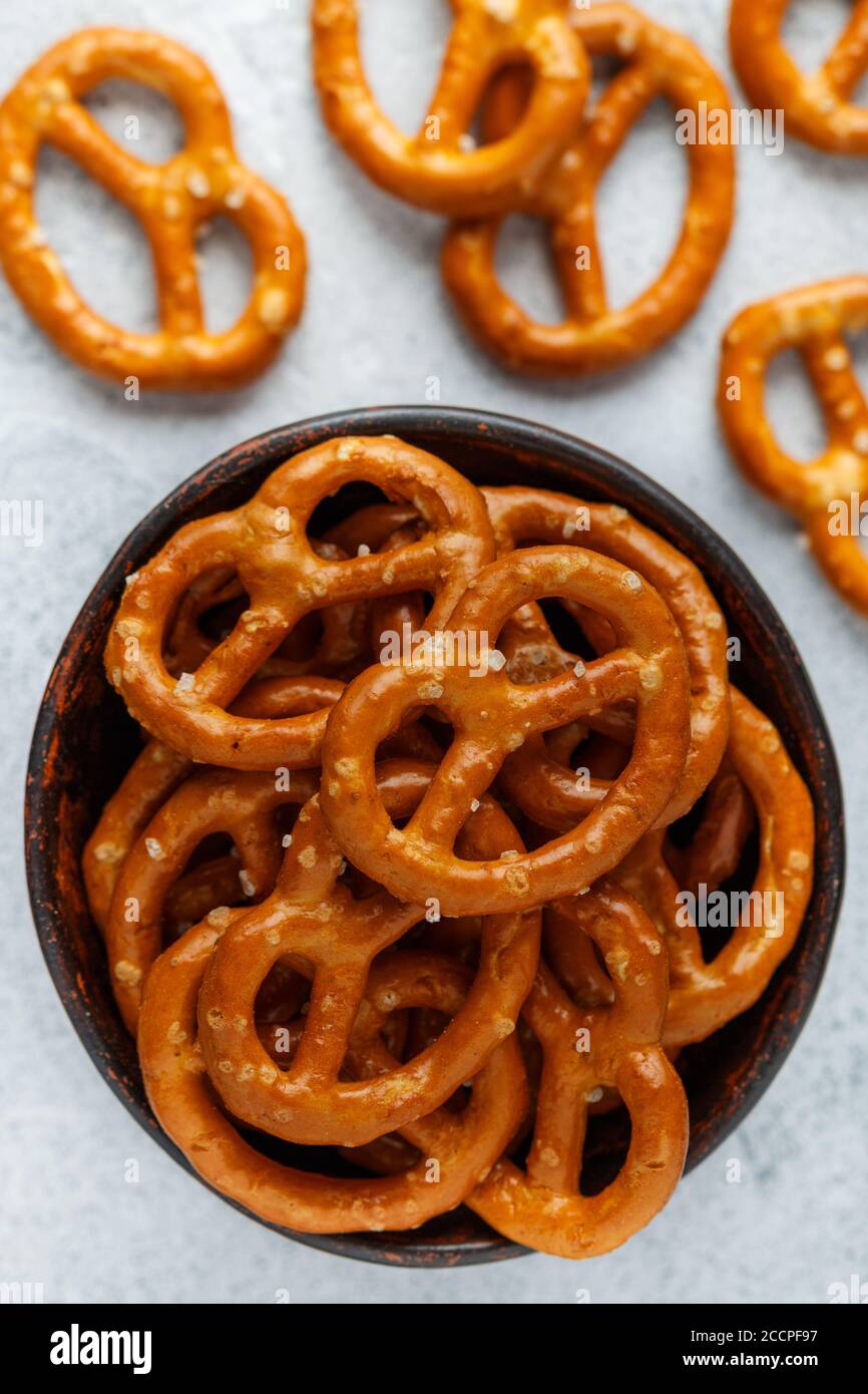 Mini pretzels with salt in a ceramic bowl closeup. Traditional German