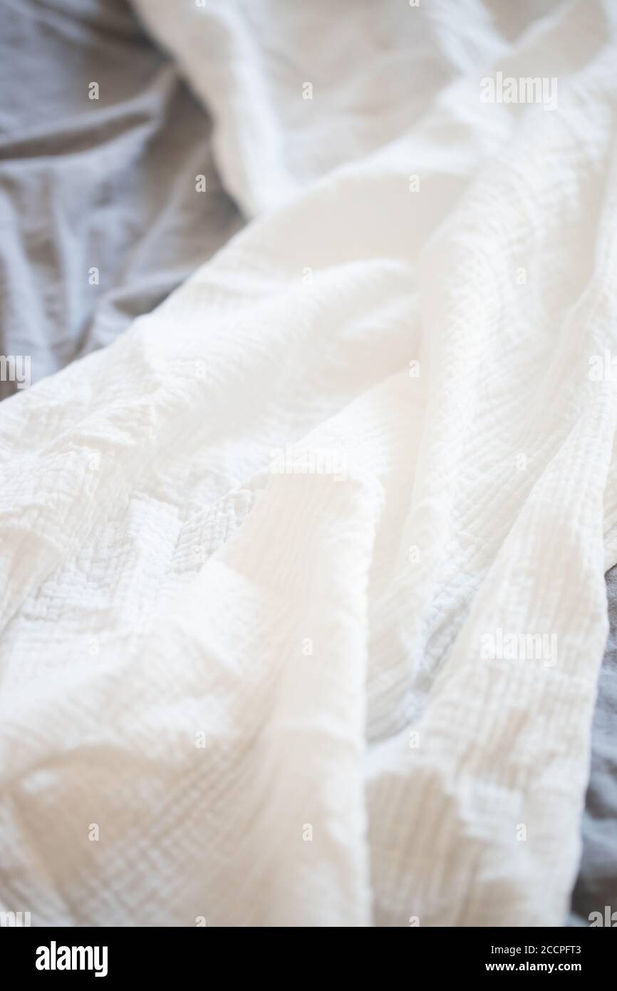 Beautiful white muslin fabric on a grey background Stock Photo