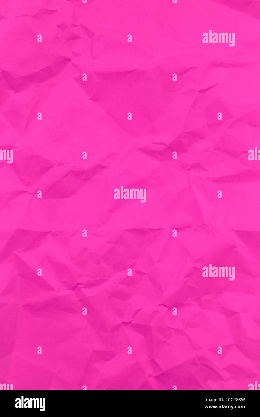 Textured crumpled pink paper background. Vertical Stock Photo