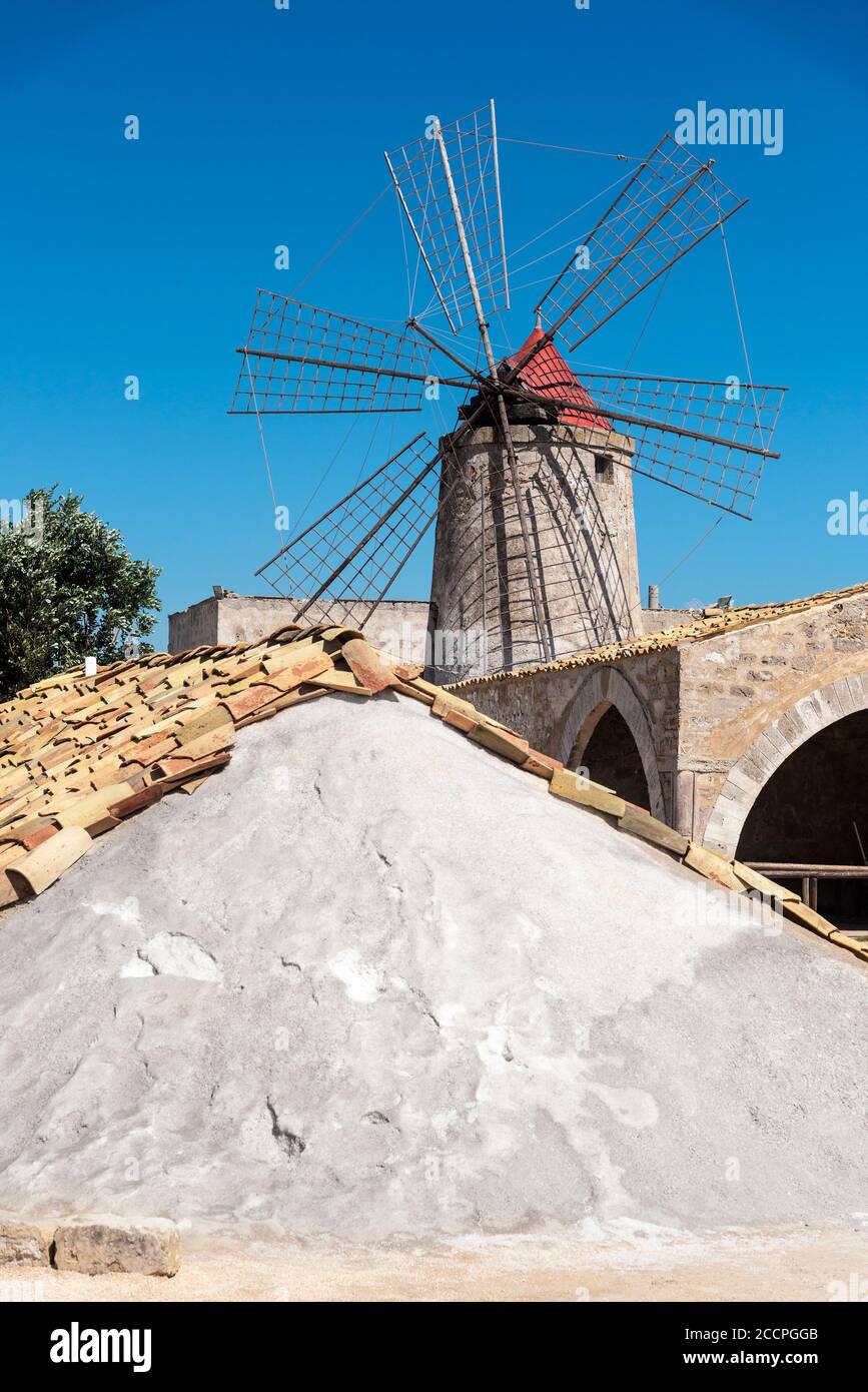 A mound of harvested salt protected with rooftiles at the saltpans at Nubia, south of  Trapani, on the west coast of Sicily, Italy. Stock Photo