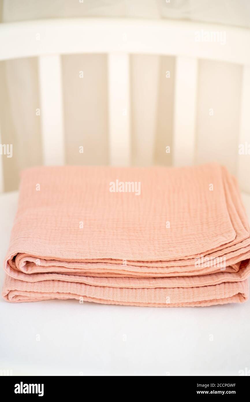 Closeup of a beautiful pink baby blanket on a white background Stock