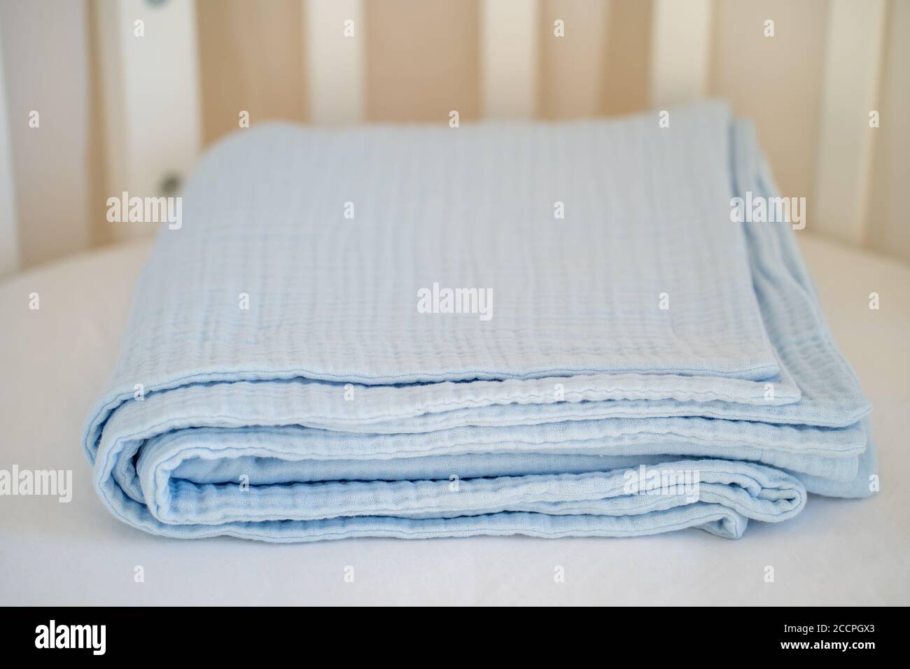 Closeup of a beautiful blue baby blanket on a white background Stock Photo