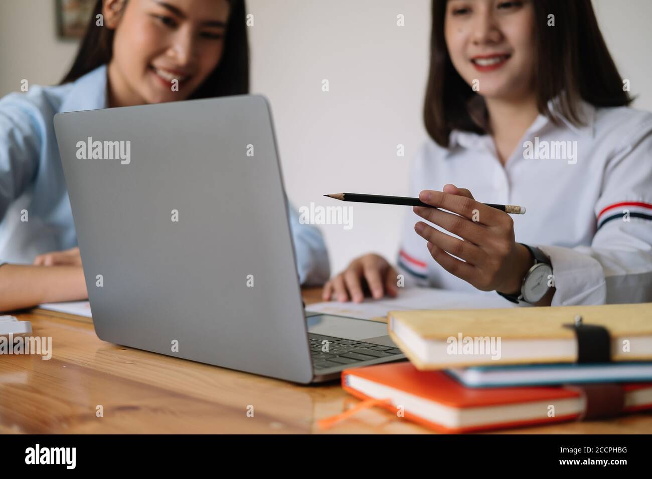 Asian business adviser meeting to analyze and discuss the situation on the financial report in the meeting room. Financial advisor and accounting Stock Photo