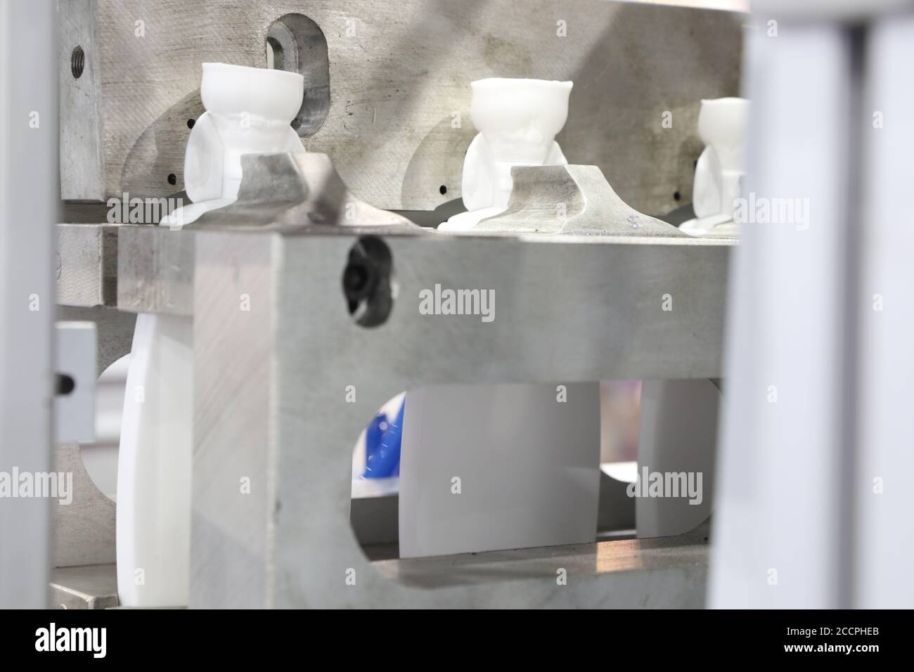 Extrusion Blow Moulding Process for making white plastic bottle Stock