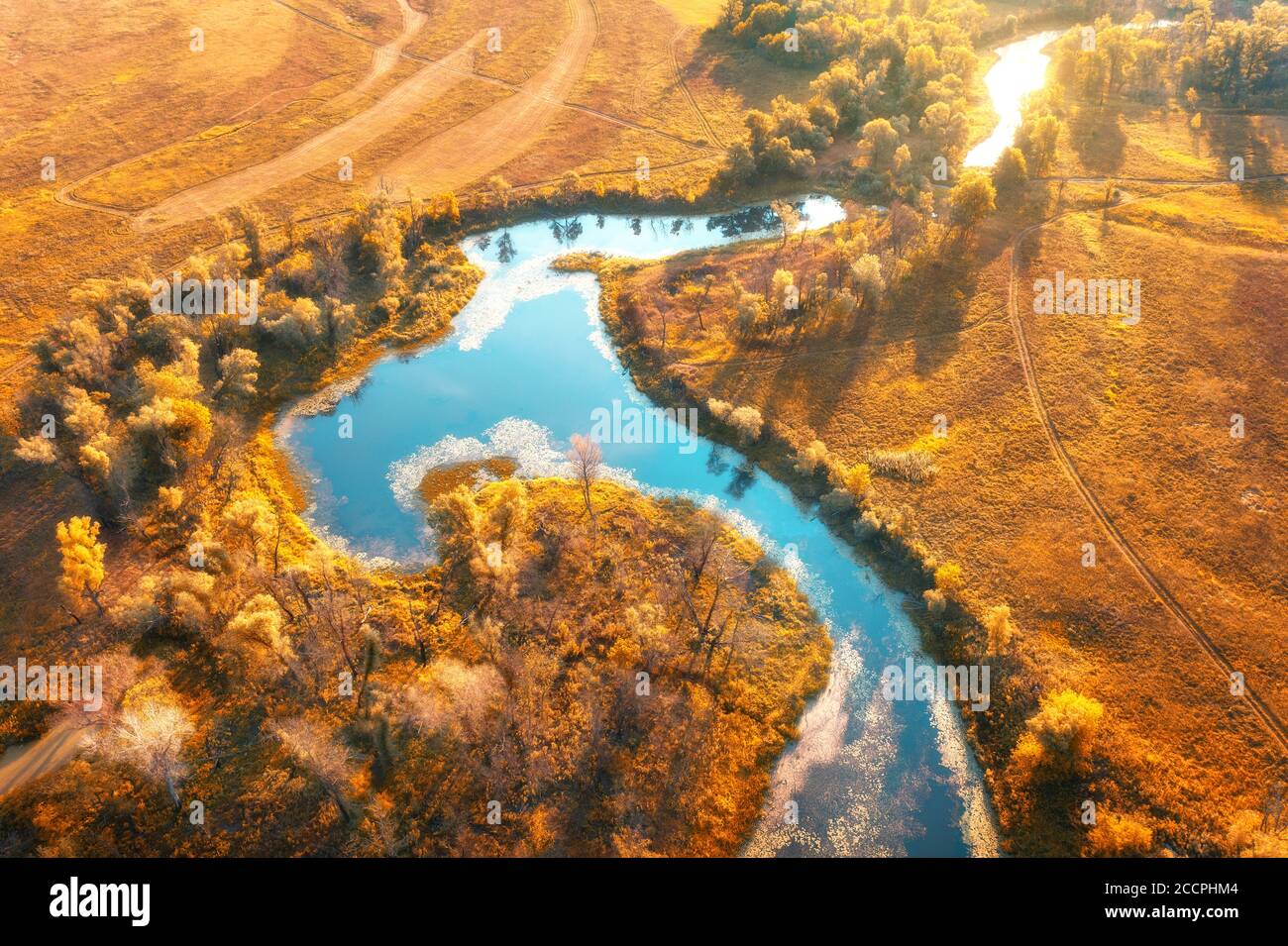 Aerial view of curving river at sunrise in autumn. View from air Stock Photo