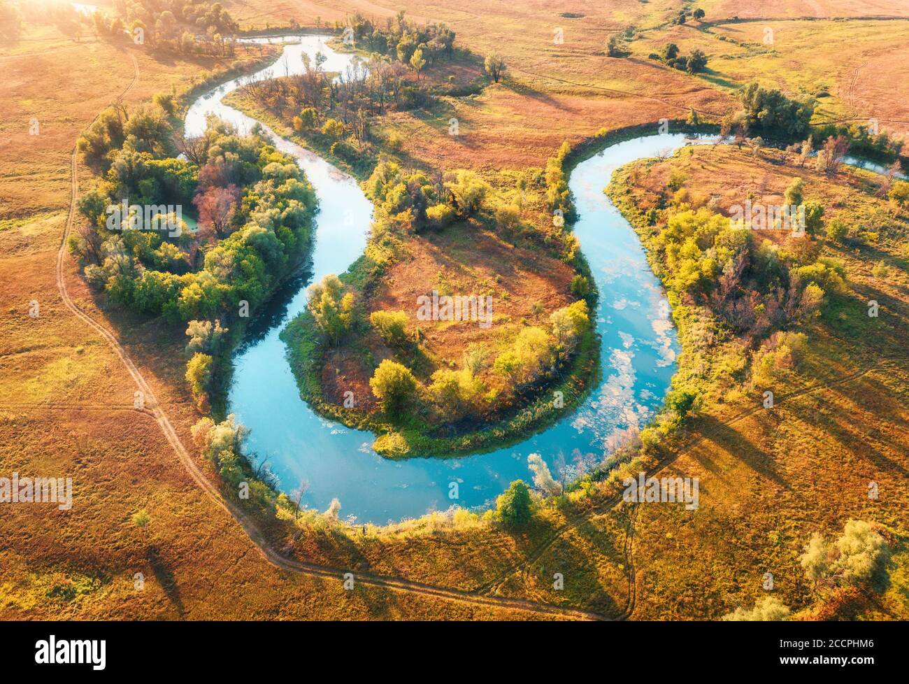 Aerial view of curving river at sunrise in autumn. View from air Stock Photo