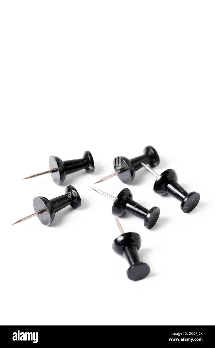 Close-up of black pins, tacks or thumbtacks with metal spiky tip