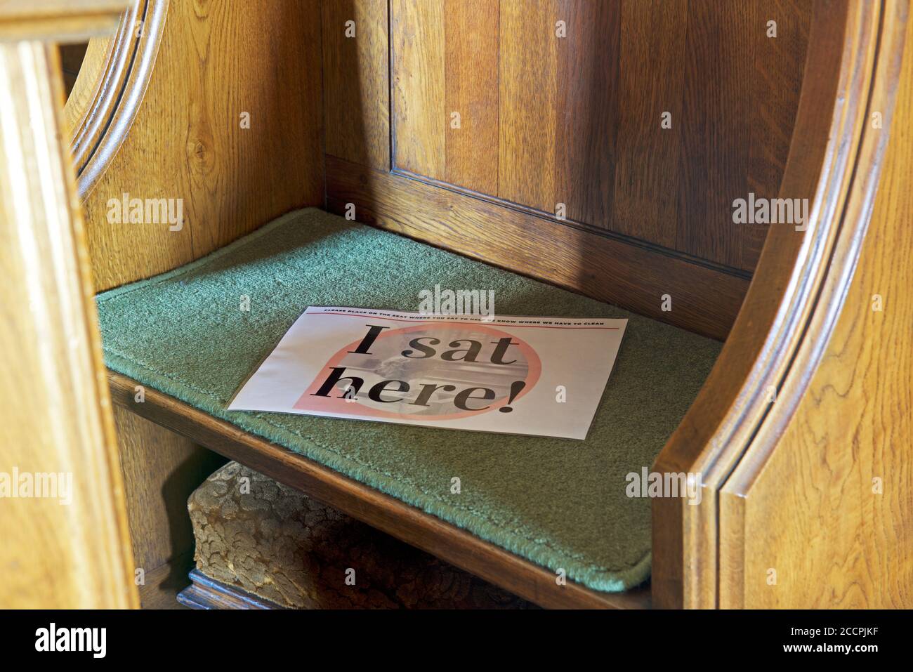 Warning - I sat here - to be used by members of church congregation, so that the seat can be cleaned and sanitised, England UK Stock Photo