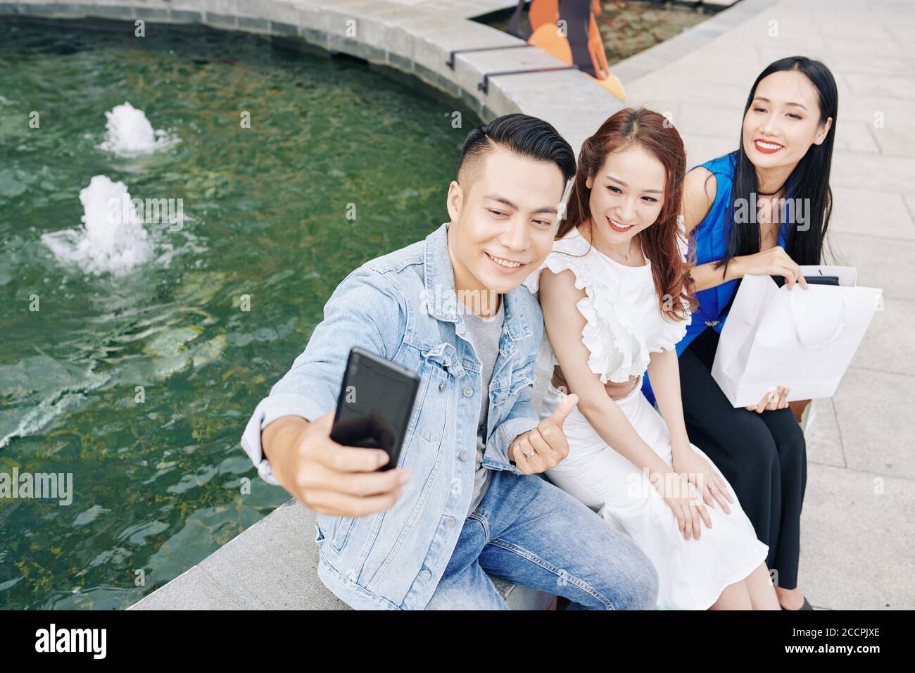Man taking selfie with friends Stock Photo