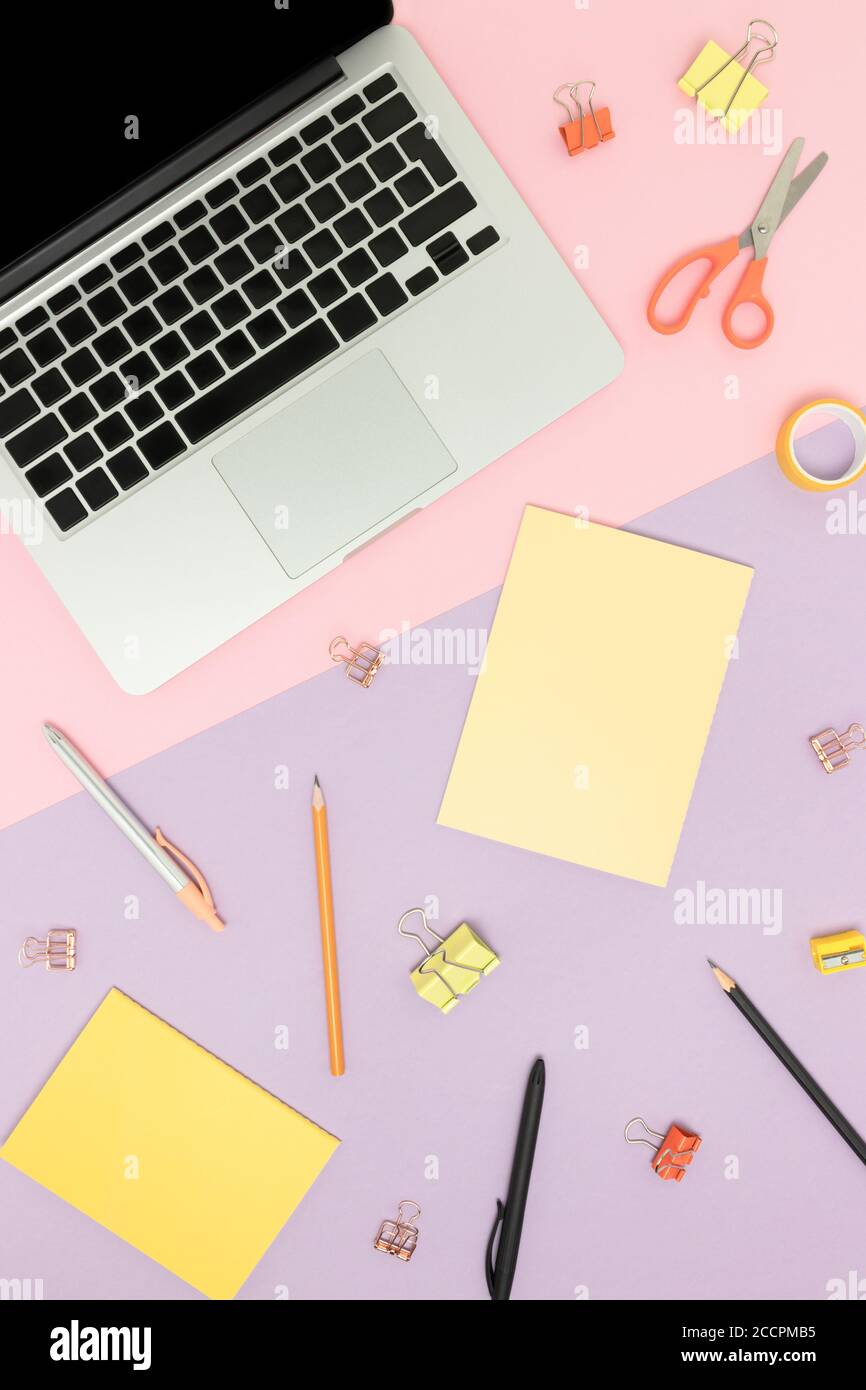 Top view of laptop and cute office supplies on a colorful ...