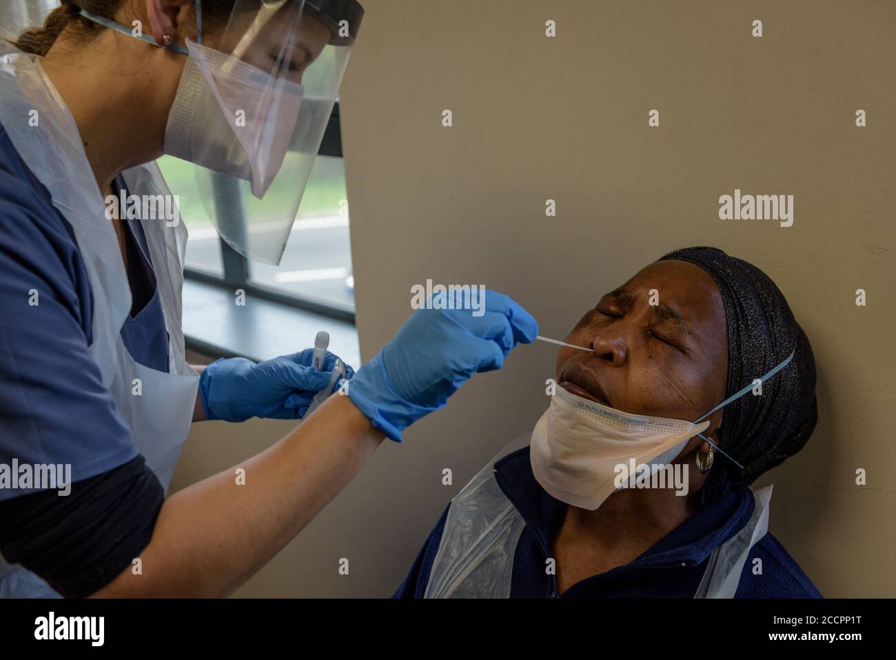 A volunteer for the Oxford vaccine trial at Cape Town's Groote Schuur Hospital is tested for COVID-19 using a nasal swab to detect the virus Stock Photo