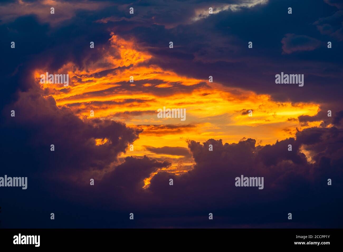fiery window in the clouds at sunset Stock Photo
