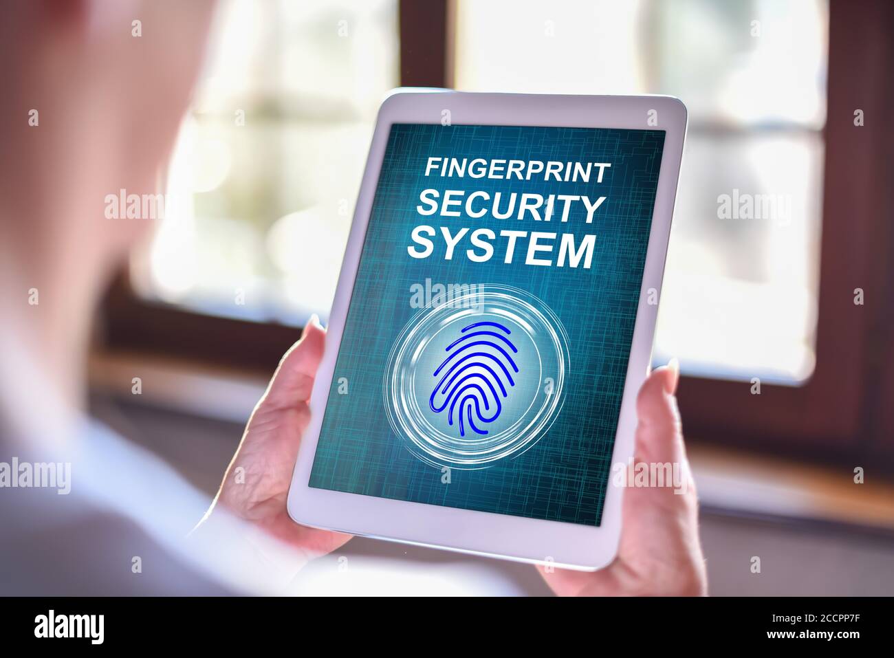 Tablet screen displaying a fingerprint security system concept Stock ...