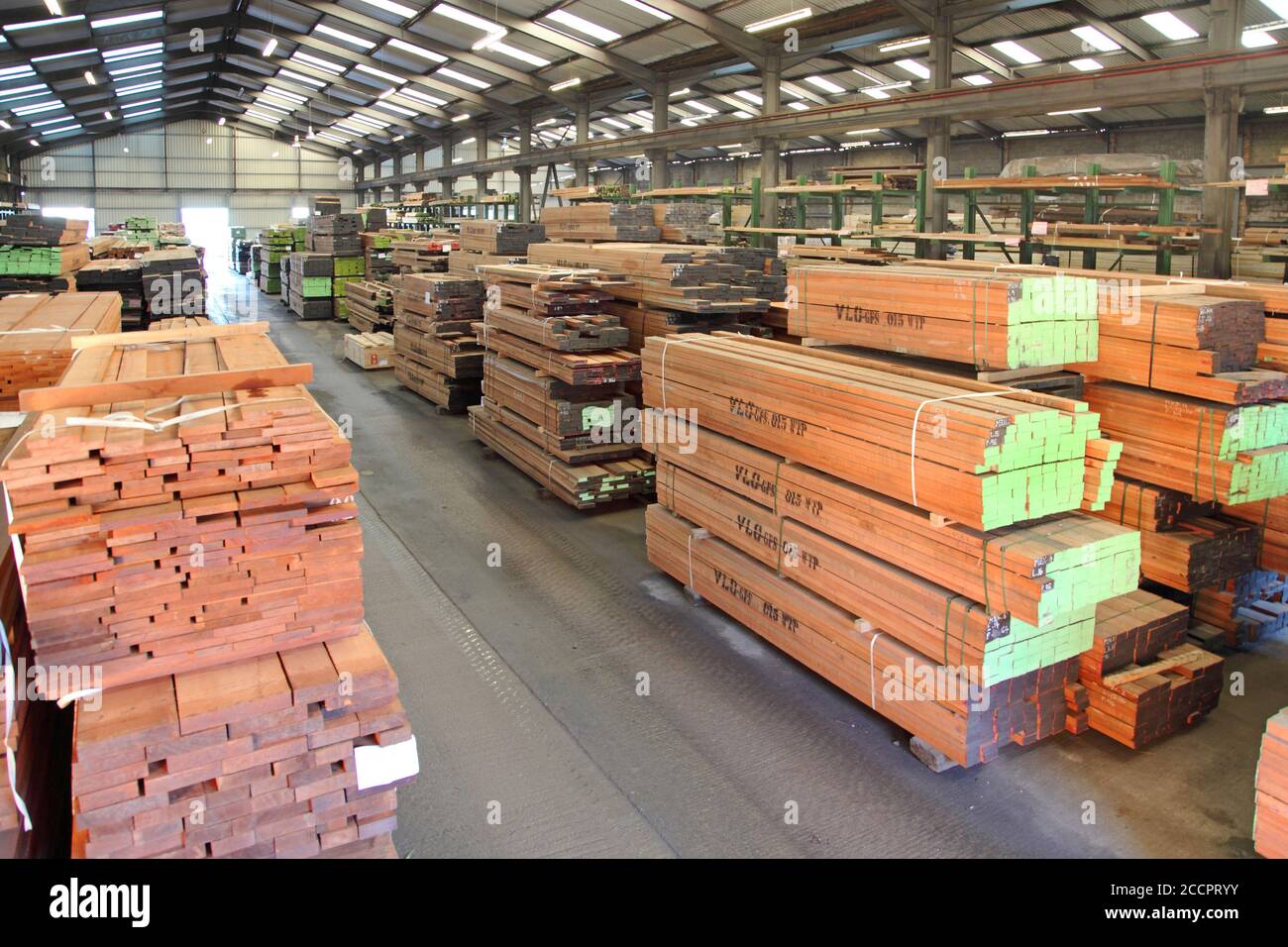 Interior of a large, UK timber warehouse showing stacks of sustainably-sourced hard wood imported from around the world. Stock Photo