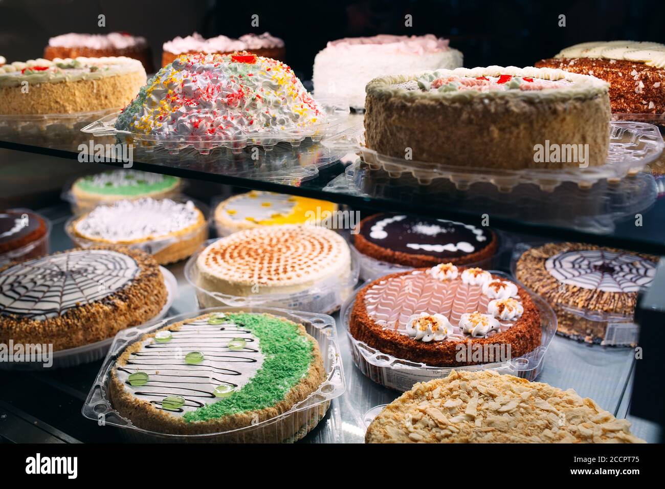 Pastry shop glass display with selection of cream or fruit cake Stock Photo Alamy