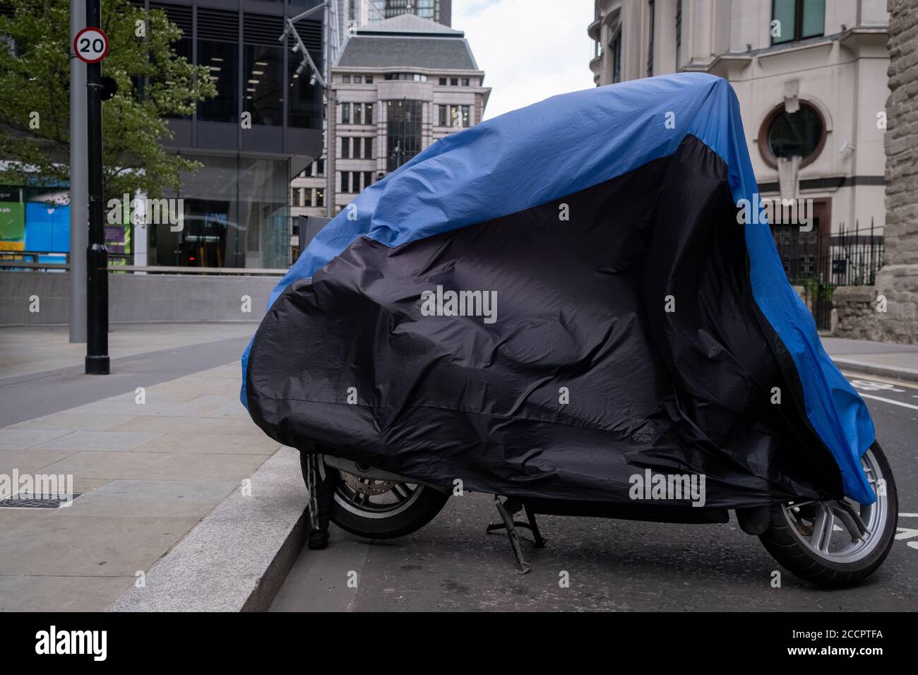 As Storm Ellen hits the capital, a motorbike's cover billows in strong winds as gusts reached the financial district, on 21st August 2020, in London, England. Stock Photo