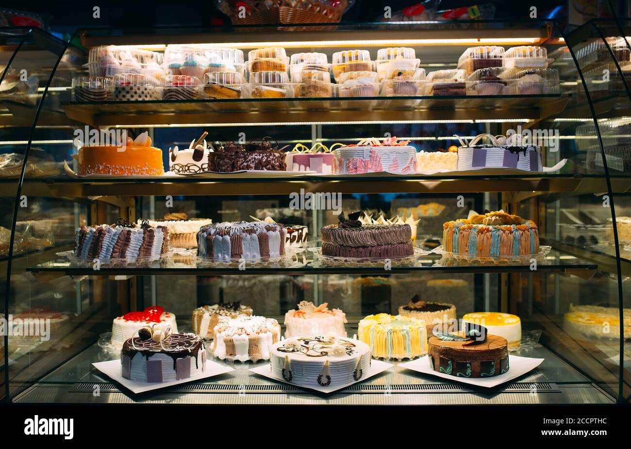 Pastry shop glass display with selection of cream or fruit cake Stock Photo Alamy