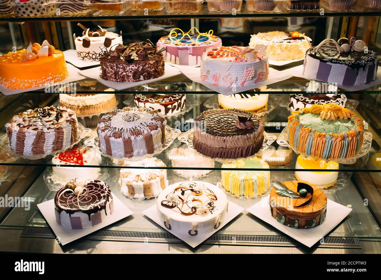 Pastry shop glass display with selection of cream or fruit cake Stock Photo Alamy