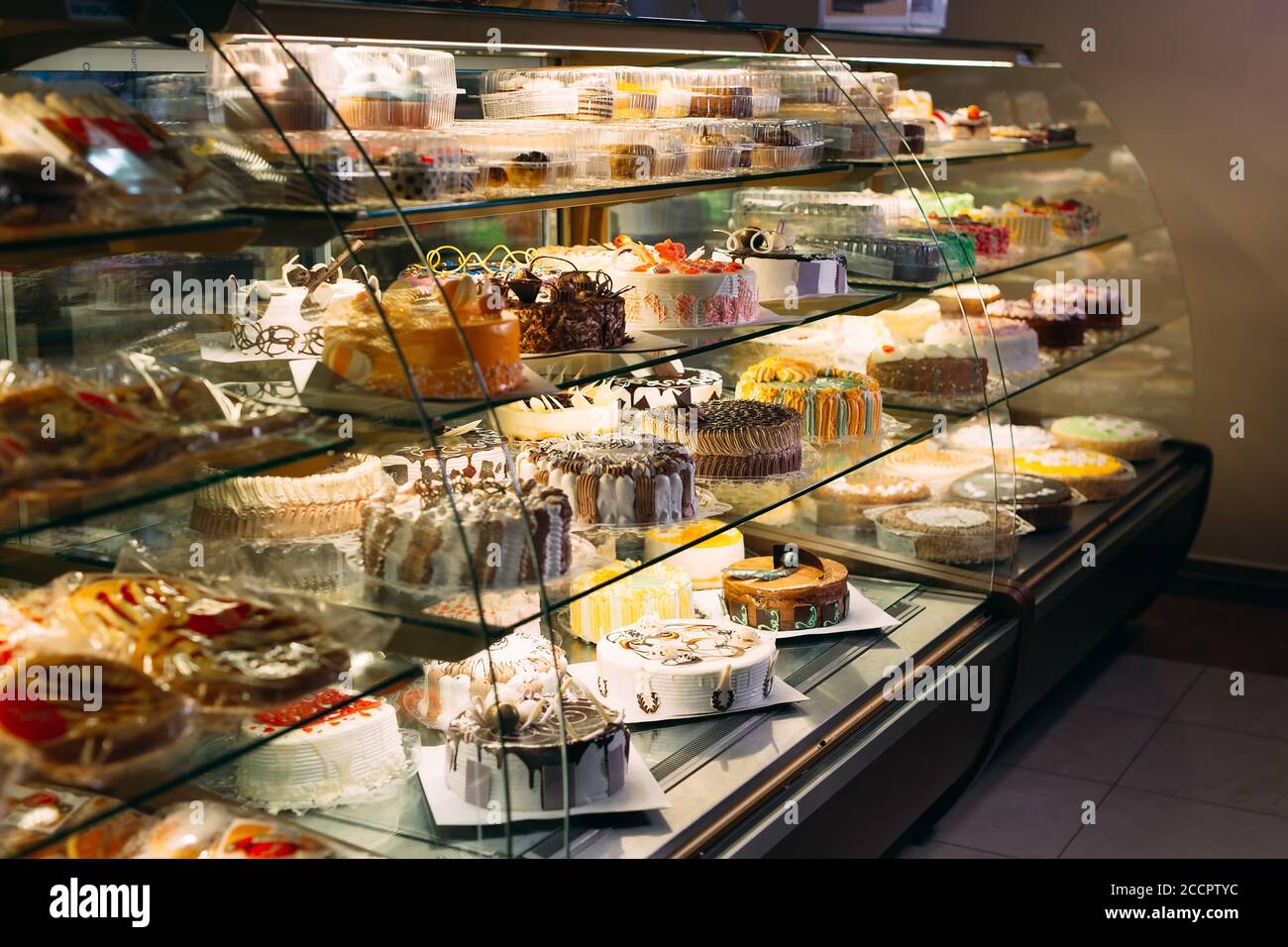 Pastry shop glass display with selection of cream or fruit cake Stock Photo Alamy