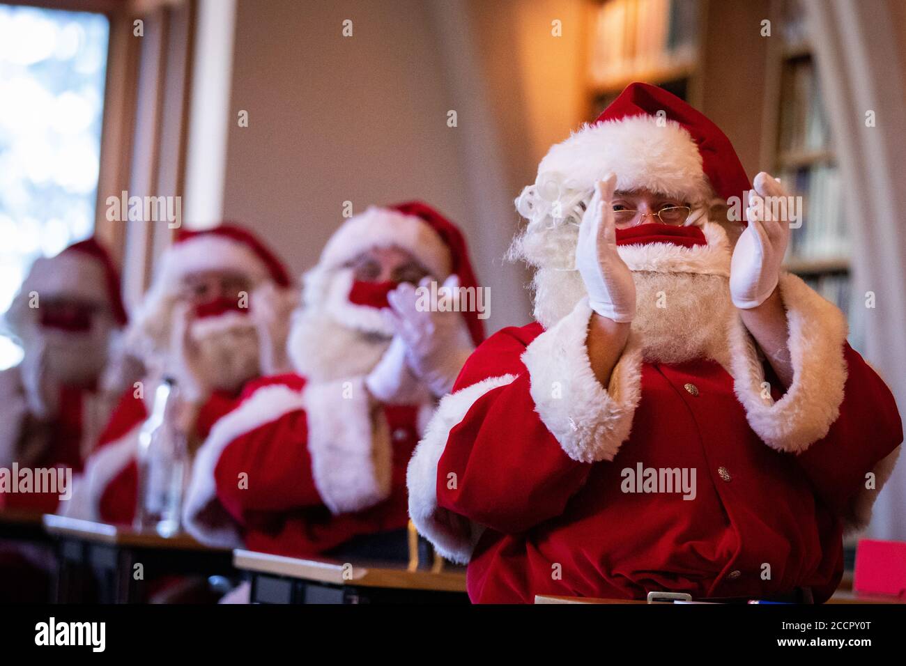 Santas at The Ministry of Fun's Summer School at Southwark Cathedral, London which aims to create COVID-safe Christmas grottos by teaching Father Christmases how to appear safely in person whilst maintaining the Christmas magic. Stock Photo