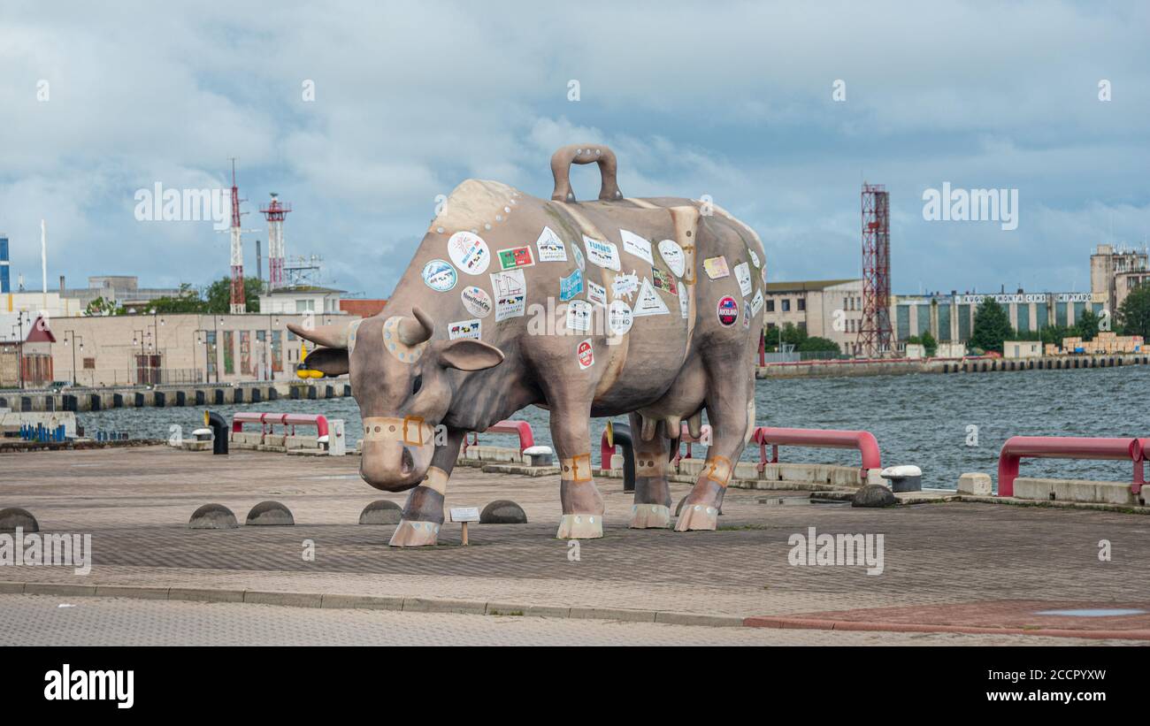 Touring Cow monument from “Cow Parade” exhibition on the riverside promenade, Ventspils. Stock Photo