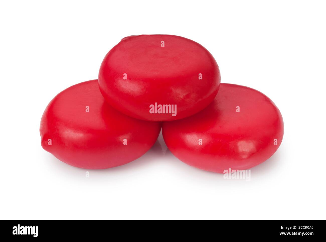 Studio shot of small red edam cheese cut out against a white background - John Gollop Stock Photo