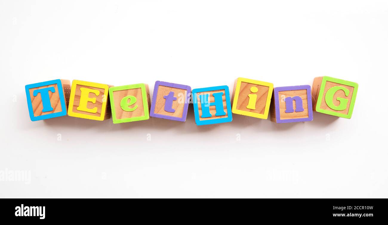 Teething word made from colourful wooden baby development blocks Stock Photo