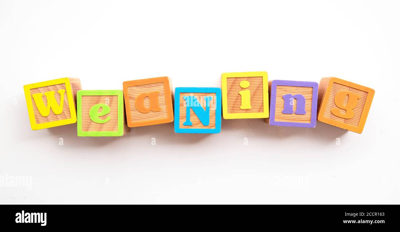Weaning word made from colourful wooden baby development blocks Stock Photo