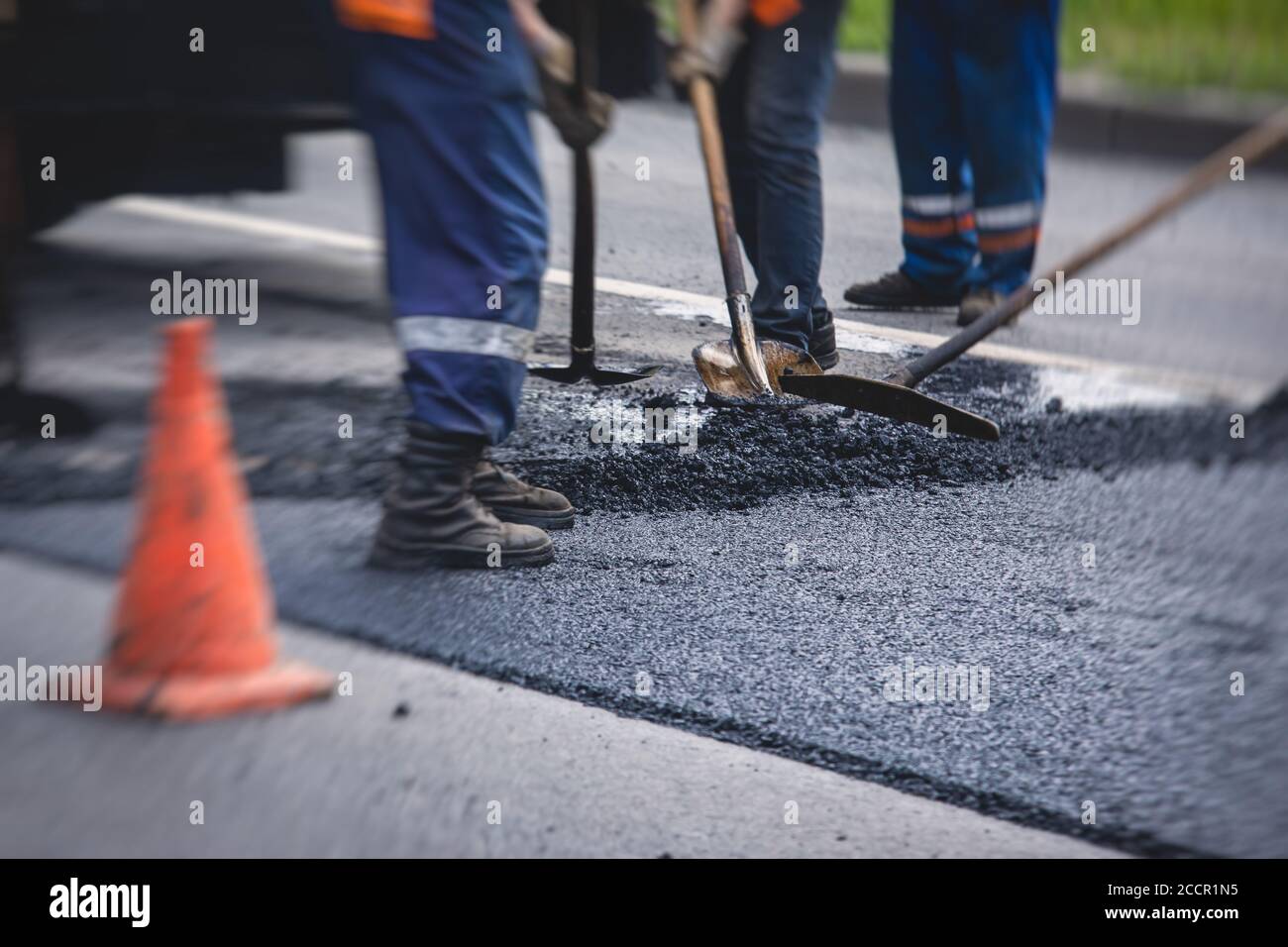 Asphalt paver machine and steam road roller during road construction ...