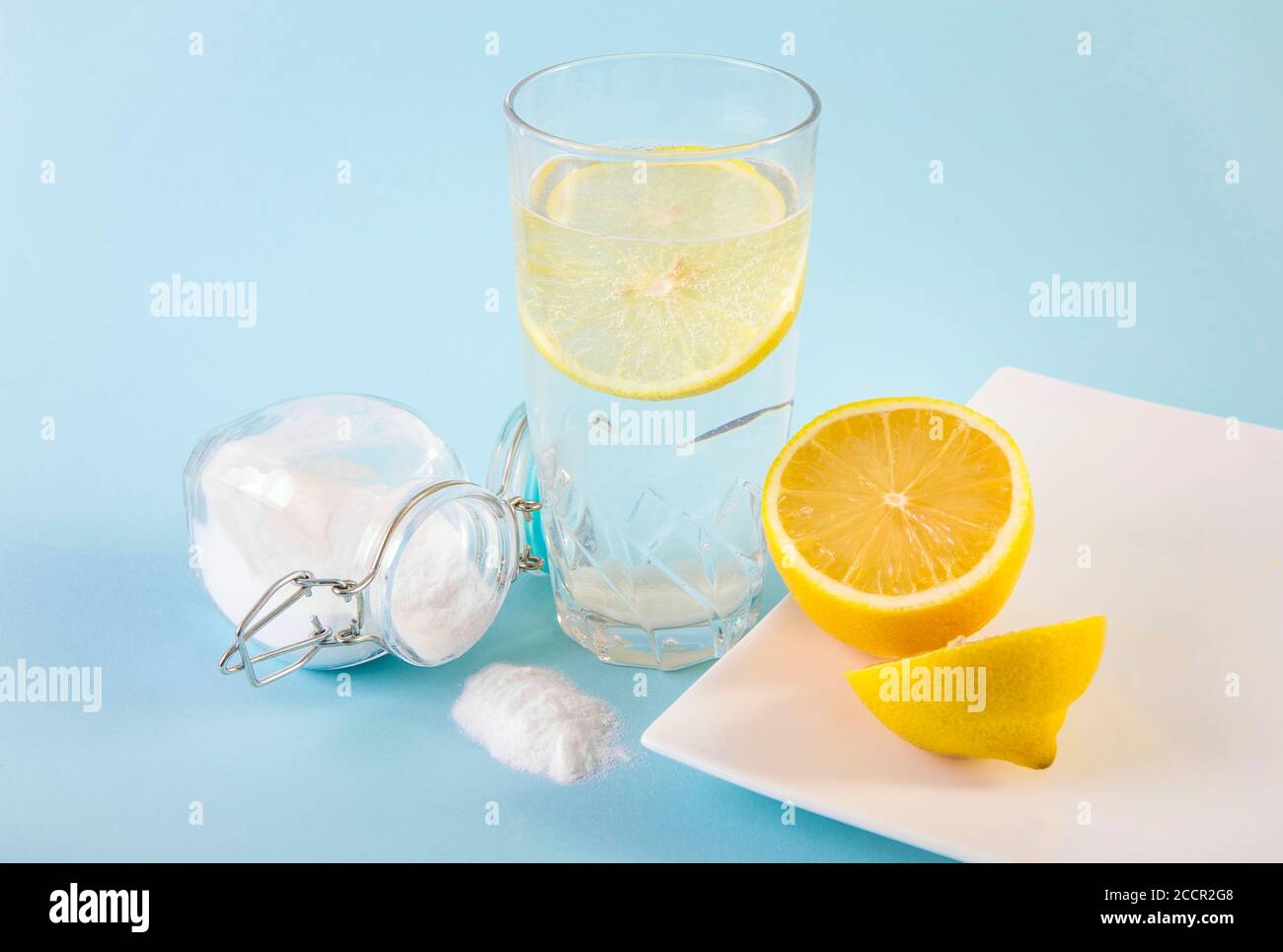 Baking soda in drinking glass with water and lemon juice, health