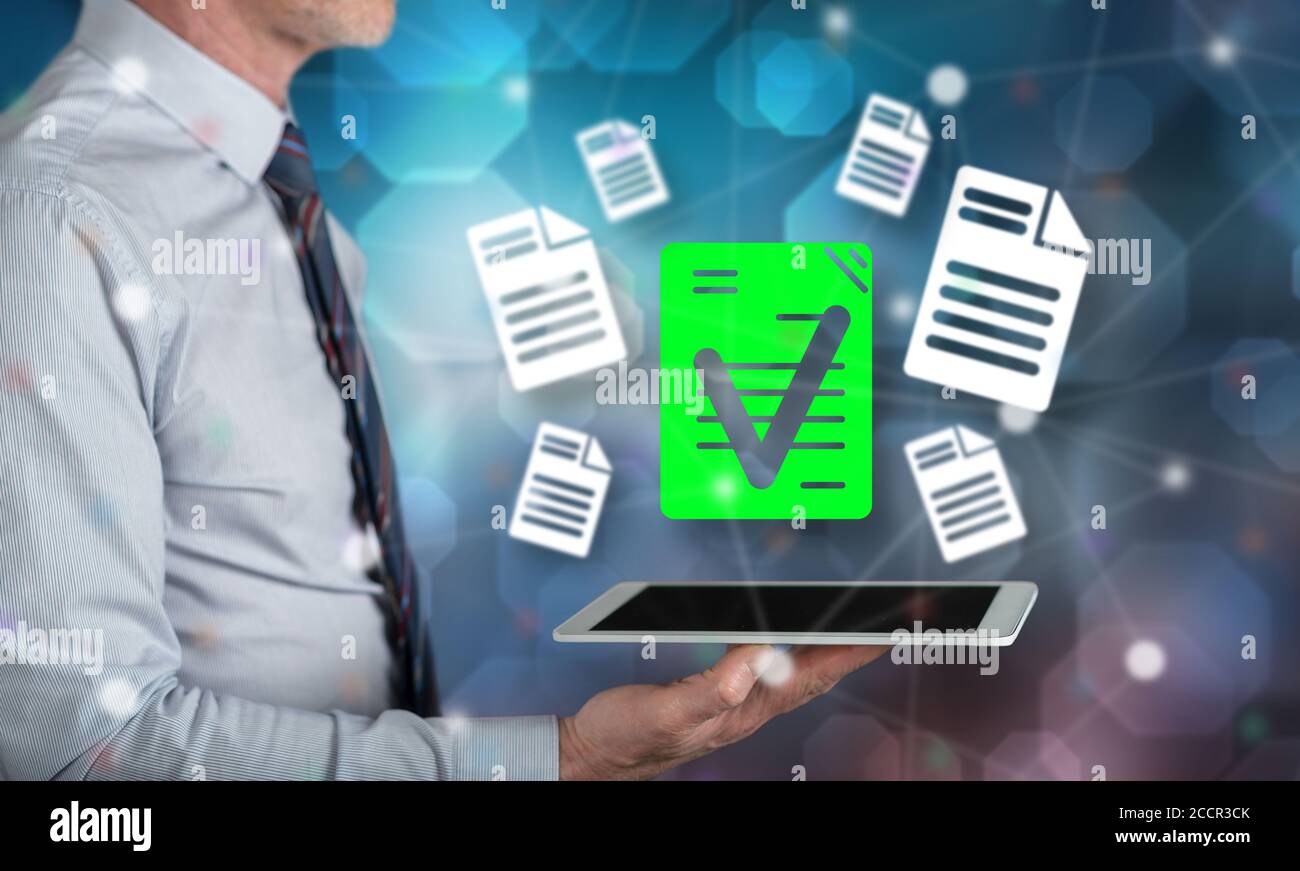 Document validation concept above a tablet held by a man Stock Photo
