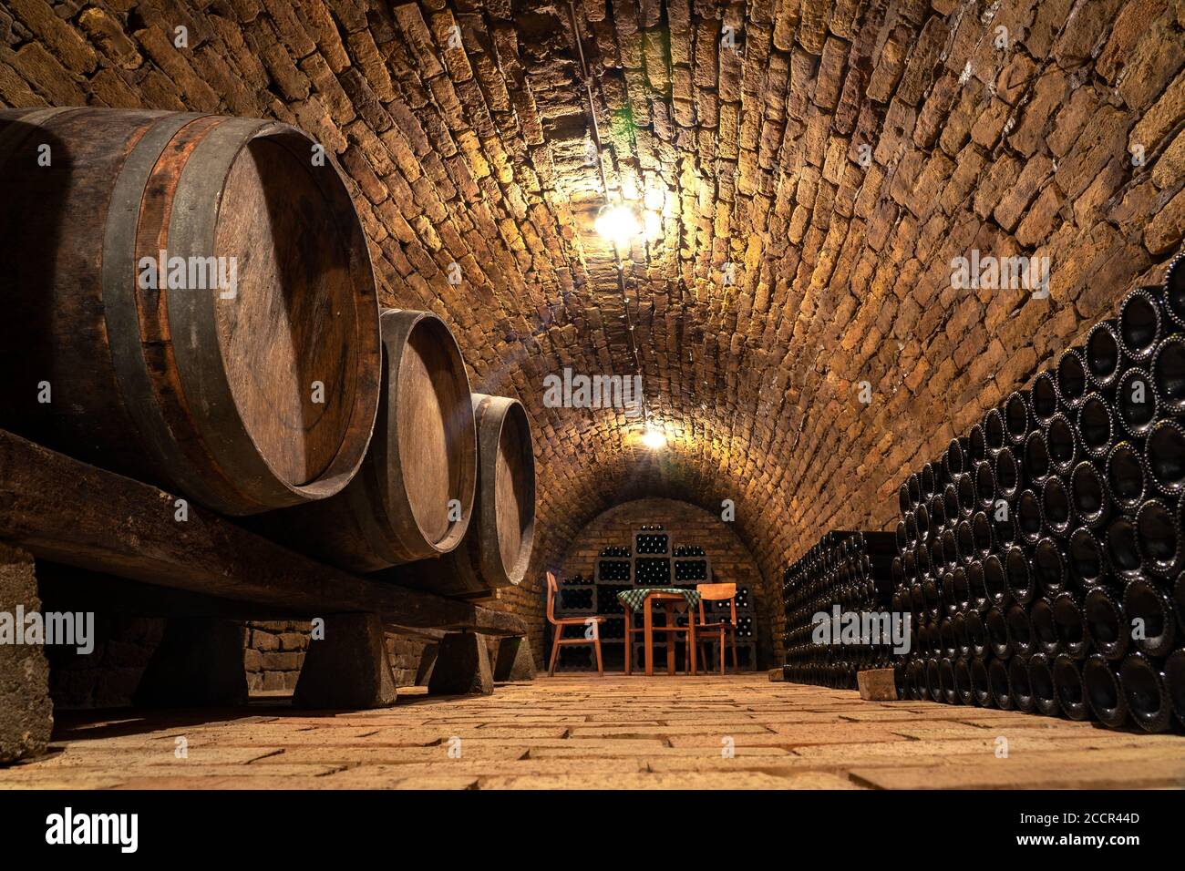 wooden old barrels in the rustic wine cellar with brick walls in hajos hungary Stock Photo