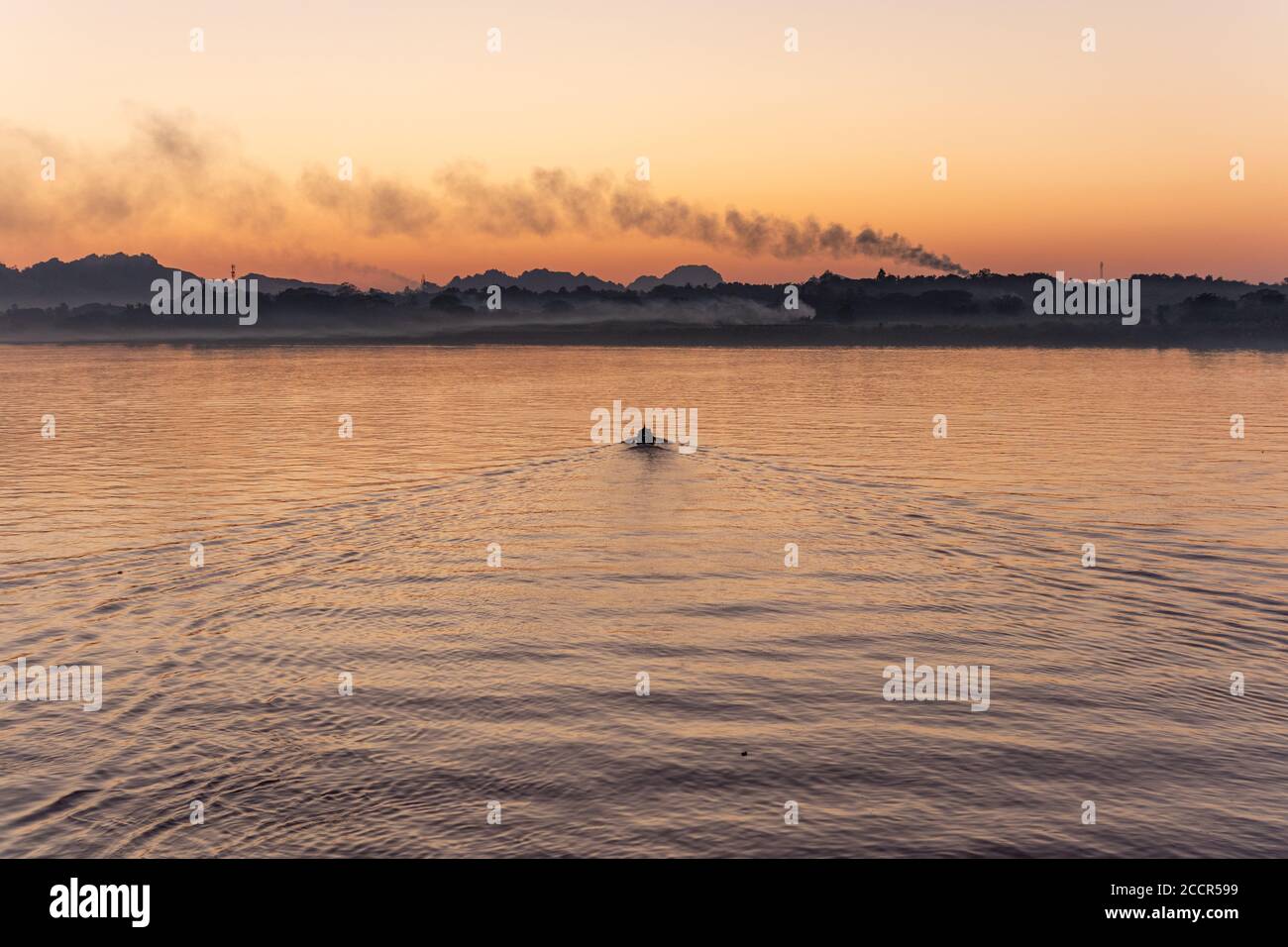 Beautiful sunset over a river. Fishing boat going towards the hills at the  background. Mysterious fog and smoke. Editing space. Hpa-An, Myanmar, Asia  Stock Photo - Alamy