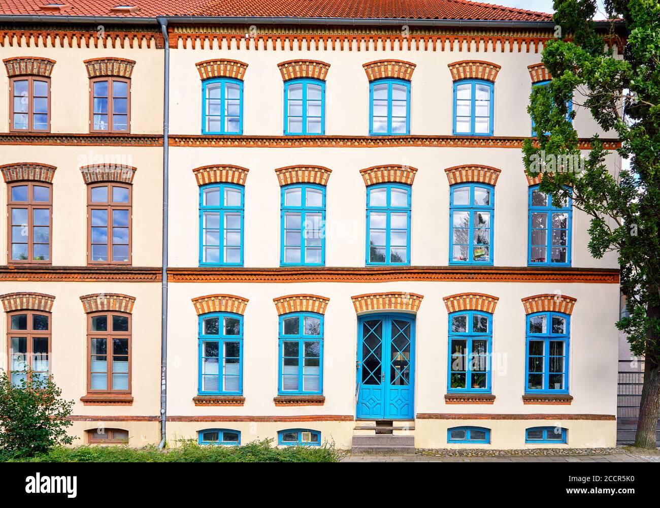 Old house with beautiful blue wooden windows and front door in the old ...
