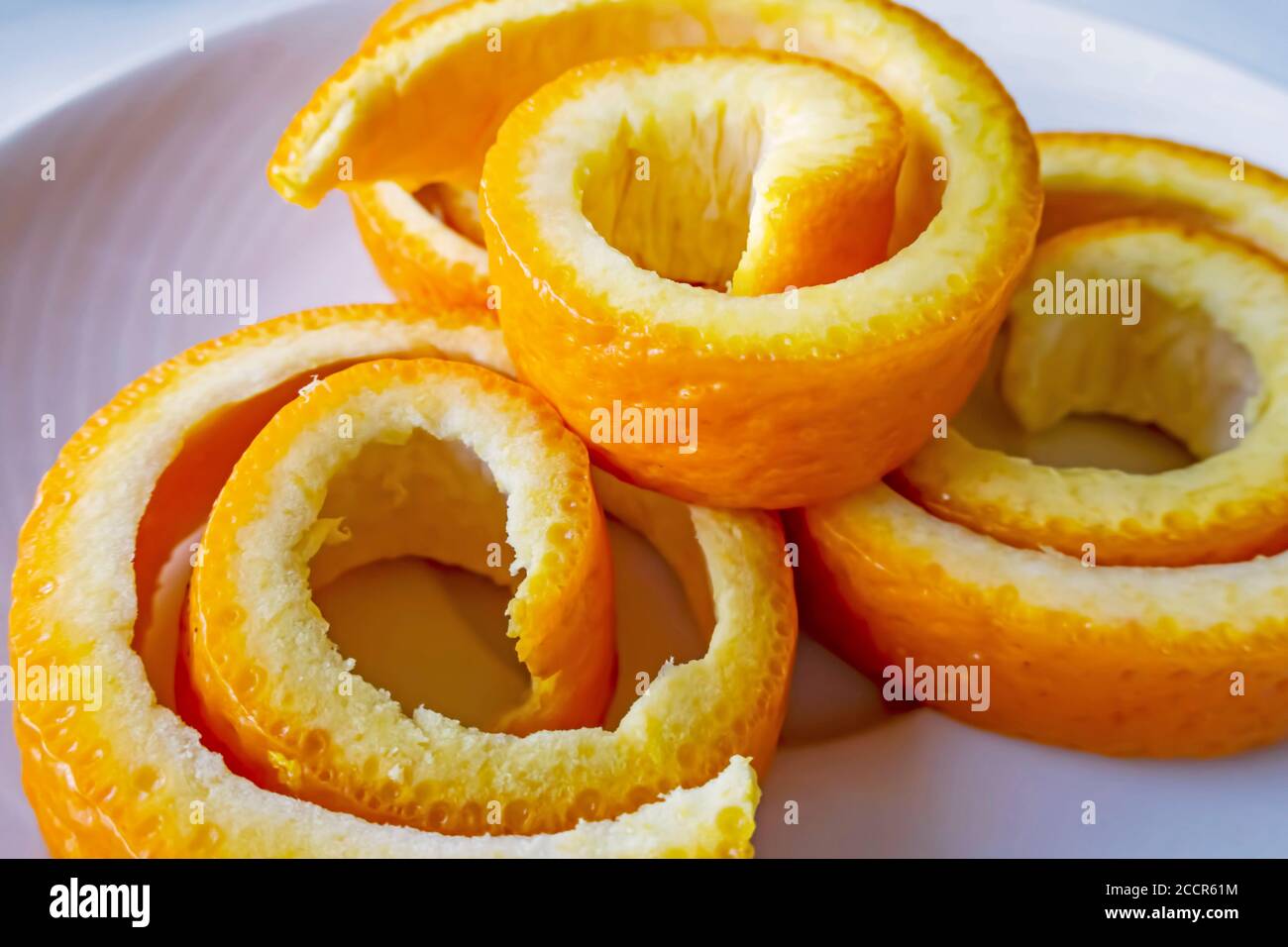 decorative orange peels on white plate Stock Photo Alamy