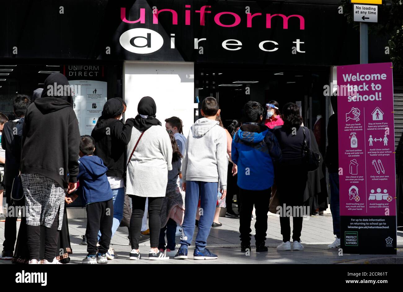 Leicester, Leicestershire, UK. 24th August 2020. Parents and children queue  to buy their school uniforms from a Uniform Direct shop during the  coronavirus pandemic. Prime Minister Boris Johnson says it is Òvitally
