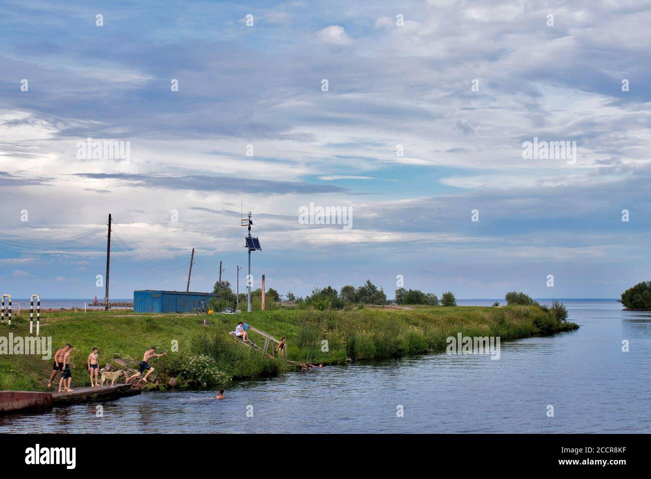 BELOZERSK, RUSSIA - 03 August 2020, Embankment in the city of Belozersk. Vologda Region. Boys swim in a canal near the lake Stock Photo