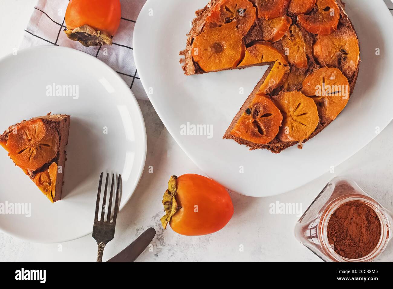 Homemade upside down persimmon cake on white table, top view Stock Photo