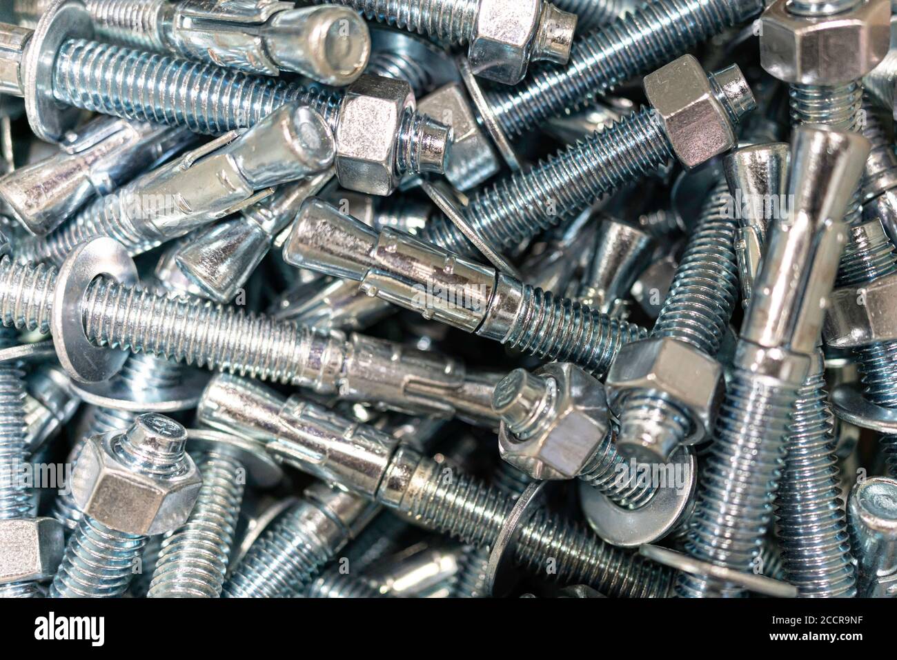 Closeup of Pile of screws and nuts and bolts in a bucket Stock Photo