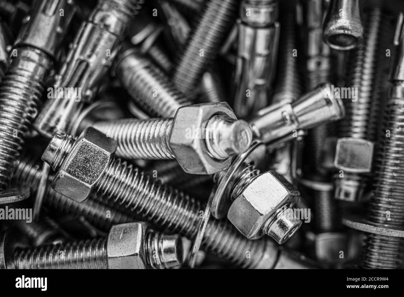 Closeup of Pile of screws and nuts and bolts in a bucket Stock Photo
