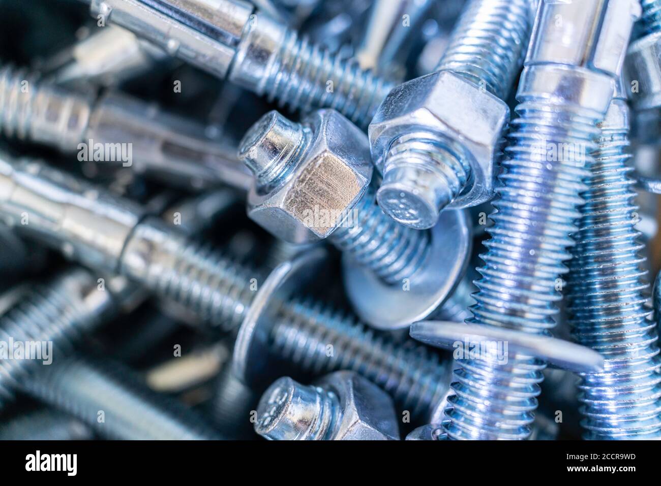 Closeup of Pile of screws and nuts and bolts in a bucket Stock Photo