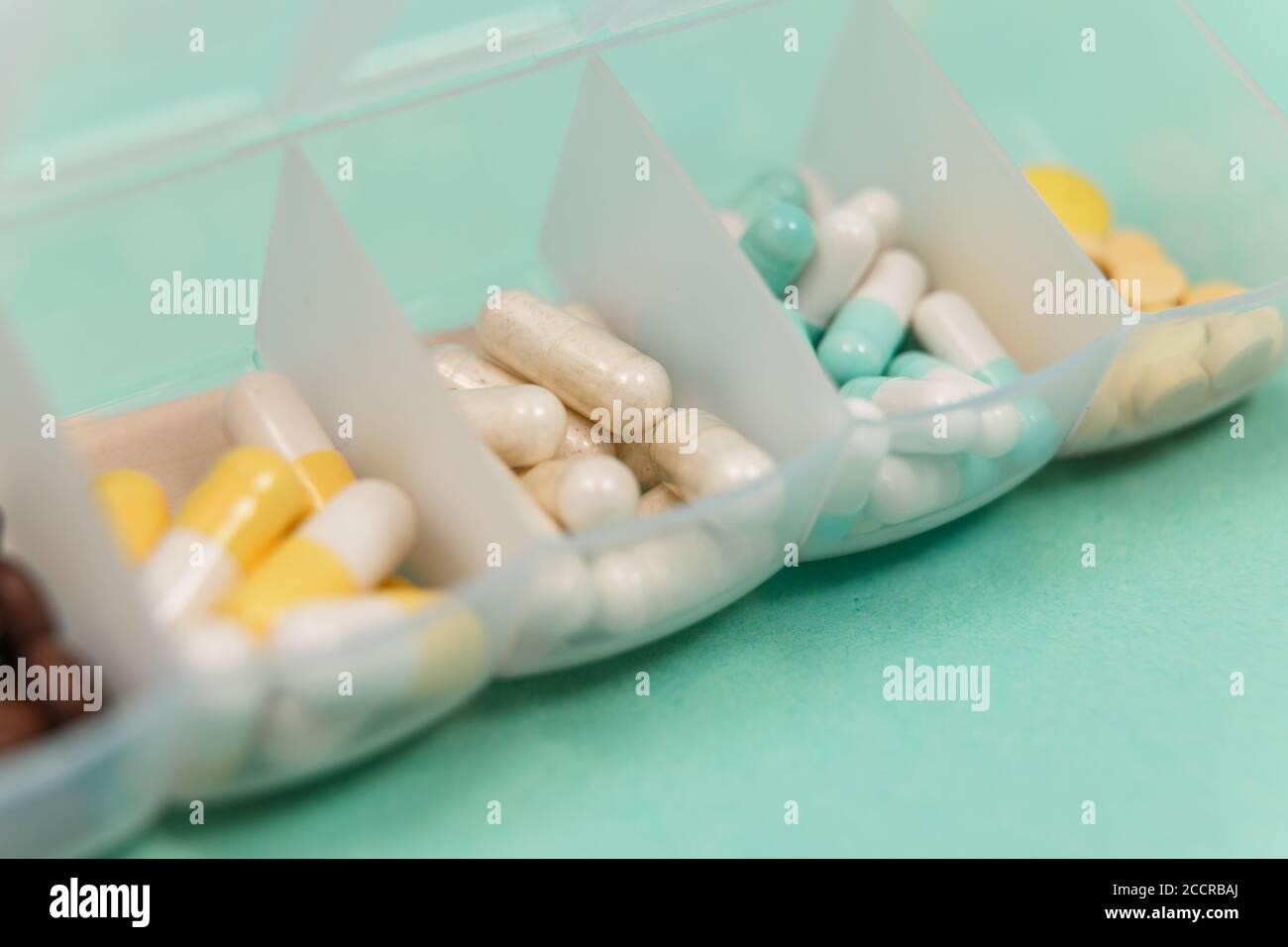 Seven day pill box with pills isolated Stock Photo